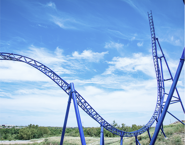 Experience a thrilling ride with the vibrant blue roller coaster tracks captured in this image. The image brings you closer to the excitement and adrenaline of theme park adventures.