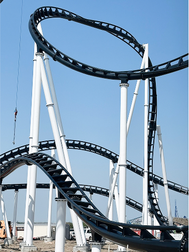 View a roller coaster construction progress snapshot captured in this image. Observe the intricate track assembly and marvel at the engineering feat behind the thrilling attraction.